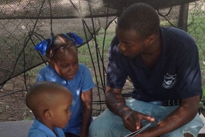 Volunteer Uncles Helping Children Read